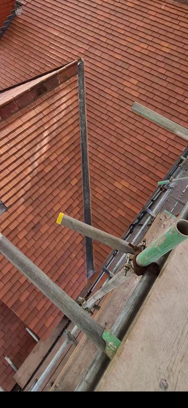 Completed clay tile coverage with clean ridge and valley detail