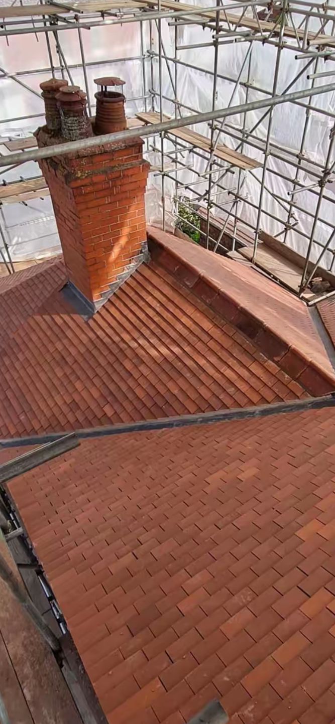 Aerial view of completed new tile roof and chimney rebuild